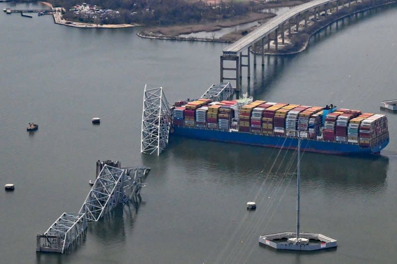 The damaged container ship "Dali" rests next to a bridge pillar in the Patapsco River after crashing into and destroying the Francis Scott Key Bridge at the entrance to Baltimore harbor in Baltimore, M.D. on Tuesday. Photo by David Tulis/UPI