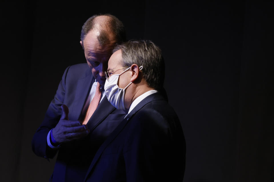 Candidate as leader of the Christian Democratic Union (CDU) Friedrich Merz, left, and North Rhine-Westphalia's Governor and candidate as leader of the Christian Democratic Union (CDU) Armin Laschet, right, talk behind the stage while the third candidate holds his speech on the second day of the party's 33rd congress held online because of the coronavirus pandemic, in Berlin on January 16, 2021. German Chancellor Angela Merkel’s party is choosing a new leader on Saturday, eight months before voters decide who will succeed Merkel in a national election. (Odd Andersen/Pool via AP)