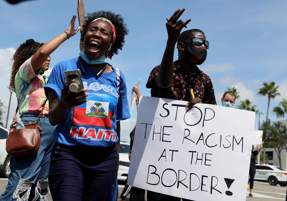 Protesters at a USCIS immigration services building in Miami on Wednesday denounce the expulsion of Haitian refugees from Del Rio, Texas. 