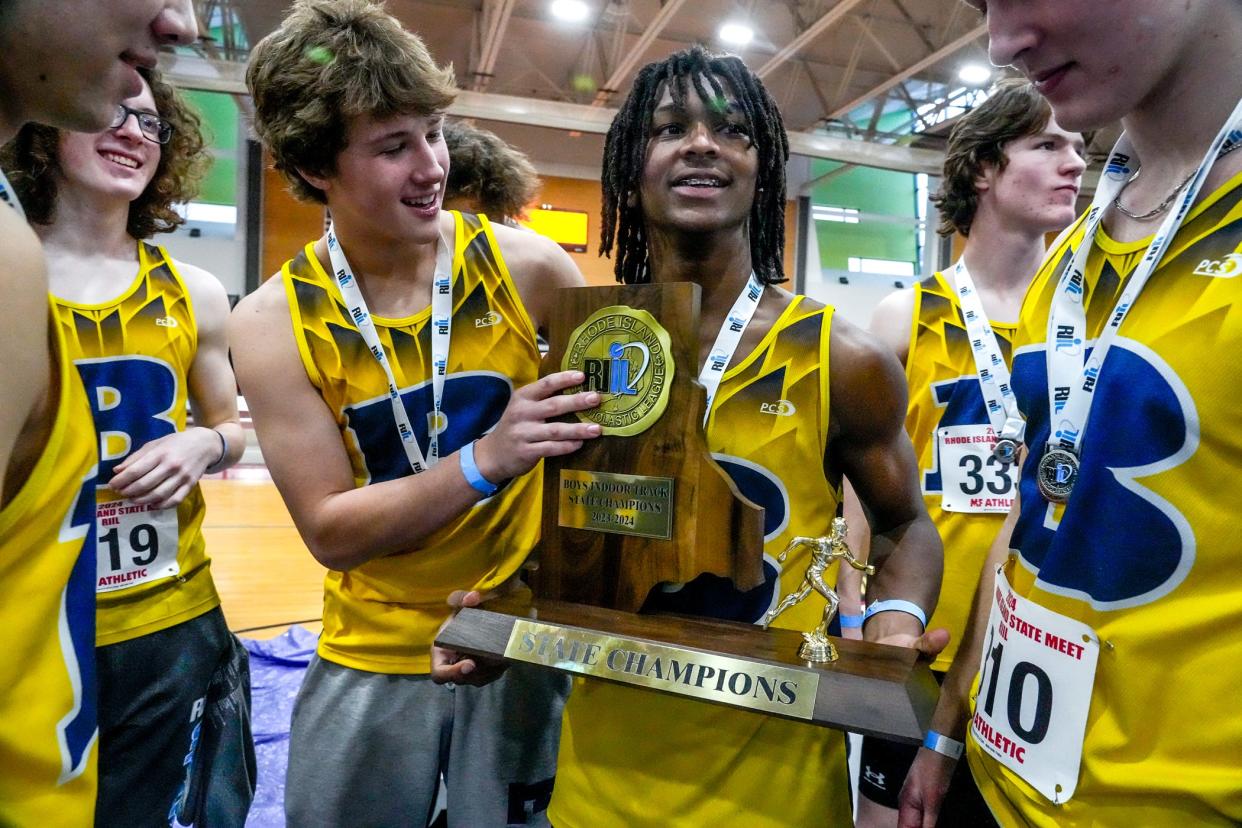 Barrington's Chucky Potte, right, and Ryan Martin hold the team trophy for Boys Indoor Track State Champions