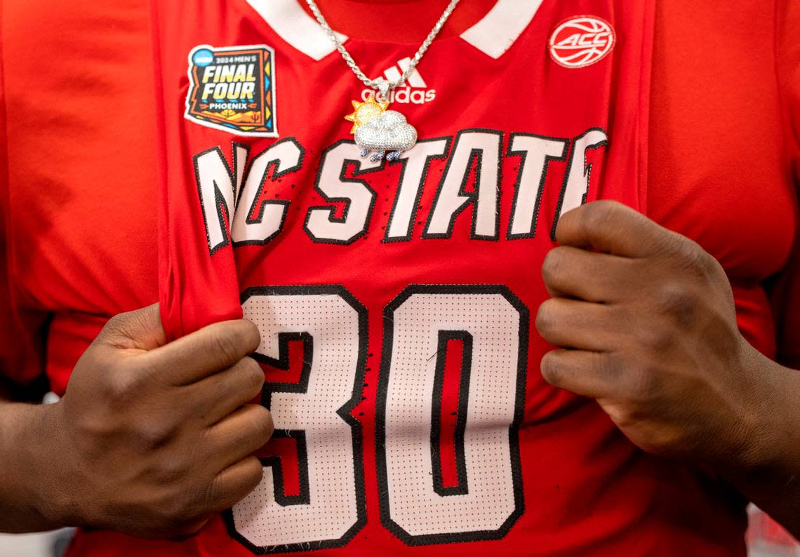 N.C. State’s D.J. Burns Jr. (30) grasps his jersey as he takes questions from the media following the Wolfpack’s loss to Purdue in the NCAA Final Four National Semifinal game on Saturday, April 6, 2024 at State Farm Stadium in Glendale, AZ. Robert Willett/rwillett@newsobserver.com