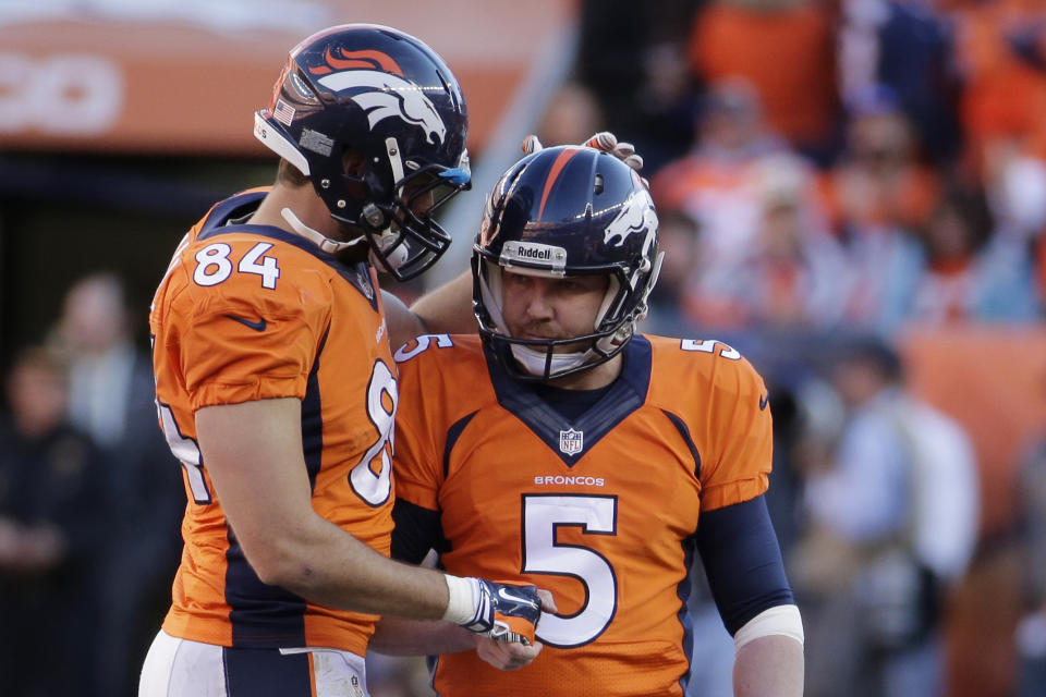 Denver Broncos tight end Jacob Tamme congratulates Denver Broncos kicker Matt Prater (5) on his field goal during the second half of the AFC Championship NFL playoff football game in Denver, Sunday, Jan. 19, 2014. (AP Photo/Charlie Riedel)