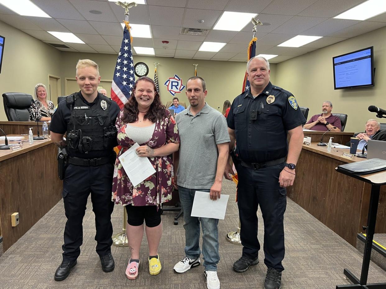Brittanie Larson and Christopher Taylor were presented with Lifesaving Awards for their work in evacuating their neighbors after a fire at their Hazen Street apartment building. From left are Officer Alex DeHoff, Larson, Taylor and Capt. Jake Smallfield.