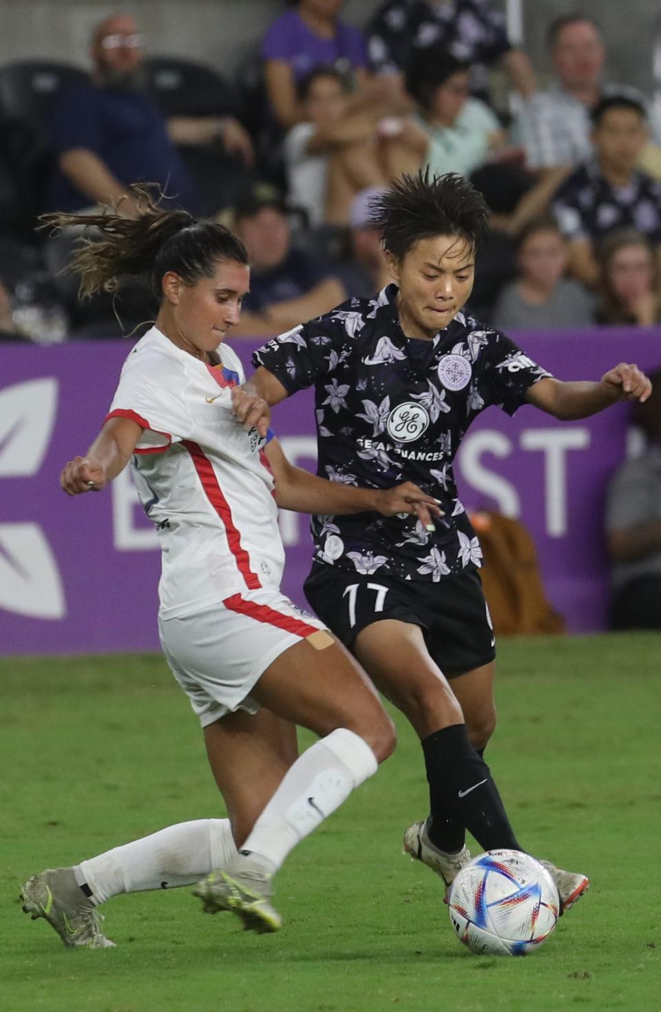 Racing Louisville FC’s Wang Shuang kicks the ball against OL Reign’s Olivia Van Der Jagt in The Women’s Cup final.Aug. 20, 2022