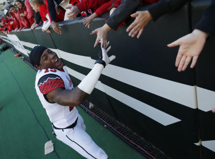 Utah defensive back Dominique Hatfield is congratulated by fans as he leaves the field Utah&#39;s 38-34 victory over Colorado in an NCAA college football game in Boulder, Colo., Saturday, Nov. 29, 2014. Hatfield intercepted a pass and scored the winning touchdown in the fourth quarter to secure the win for Utah. (AP Photo/David Zalubowski)