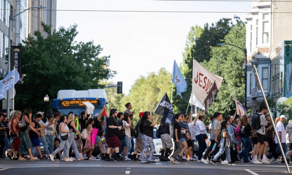 Hundreds of people march on Saturday from Ali Youssefi Square on K Street to the California Capitol for the Let Us Worship tour of state capitals led by Christian faith leader Sean Feucht, a former worship leader of Redding’s Bethel megachurch.
