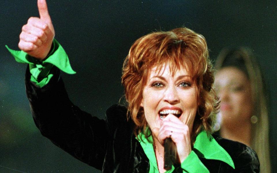 Katrina Leskanich - with her green shirt - performs at Eurovision in 1997 - Credit: AP