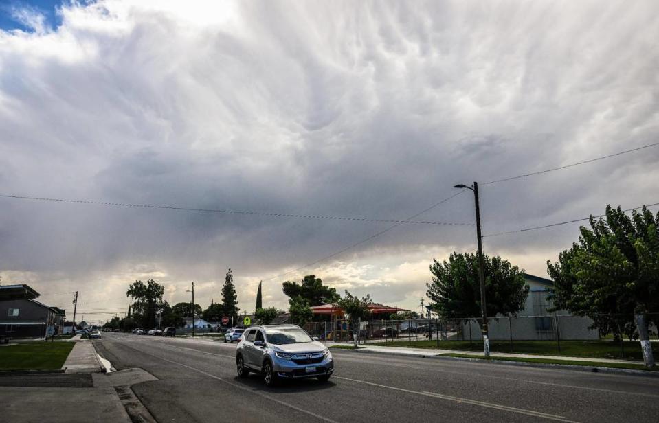 A cloud rises above Sixth Street near Washington Elementary School in Mendota on Thursday, Aug. 17, 2023.