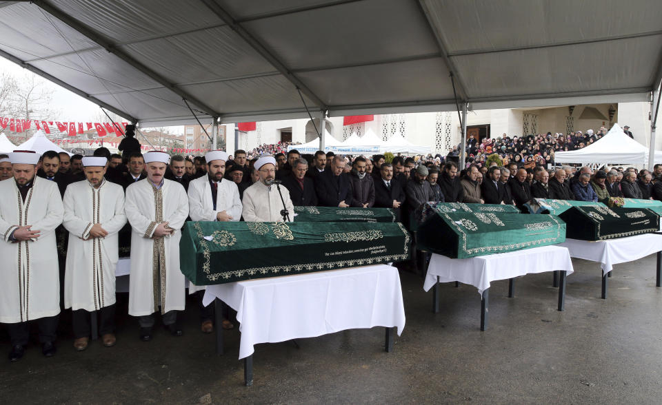 Turkey's President Recep Tayyip Erdogan, center, joins hundreds of mourners who attend the funeral prayers for nine members of Alemdar family killed in a collapsed apartment building, in Istanbul, Saturday, Feb. 9, 2019. Erdogan says there are "many lessons to learn" from the collapse of a residential building in Istanbul where at least 17 people have died.(AP Photo/Emrah Gurel)