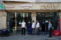 People queue in front of the exchange shop at Ferdowsi square in Tehran