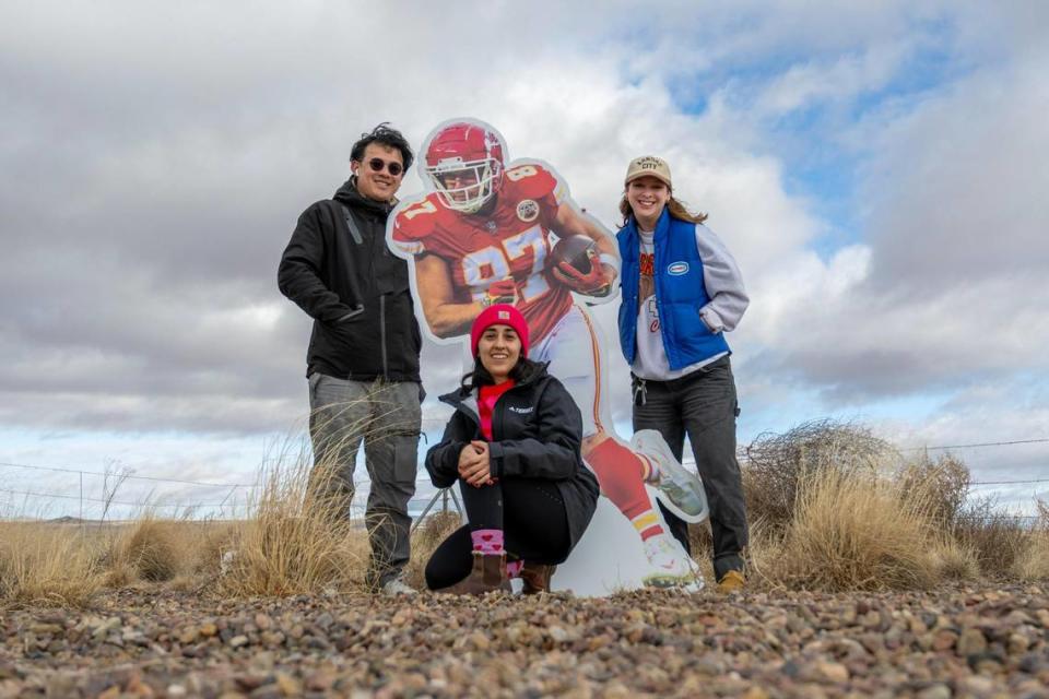 Journalists Irvin Zhang, left, Emily Curiel and Alison Booth pose for a photo alongside a life-size cutout featuring Kansas City Chiefs tight end Travis Kelce amidst the desert on Thursday, Feb. 8, 2024, in Holbrook, Ariz. The three are on The Kansas City Star Kingdom Road Trip en route to Super Bowl LVIII in Las Vegas.