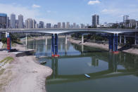 In this aerial photo, the lower than normal bank of the Jialing River is seen in southwestern China's Chongqing Municipality, Friday, Aug. 19, 2022. Ships crept down the middle of the Yangtze on Friday after the driest summer in six decades left one of the mightiest rivers shrunk to barely half its normal width and set off a scramble to contain damage to a weak economy in a politically sensitive year. (AP Photo/Olivia Zhang)