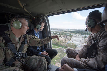 Jared Kushner (middle), Senior Advisor to President Donald J. Trump, is pictured during a helicopter transit over Baghdad, Iraq, in this April 3, 2017 handout photo. Navy Petty Officer 2nd Class Dominique A. Pineiro/DoD/Handout via REUTERS