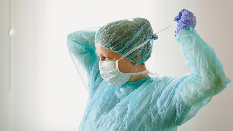 Nurse wearing protective mask and gloves.