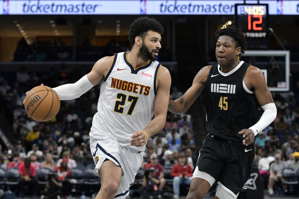 Denver Nuggets guard Jamal Murray (27) handles the ball against Memphis Grizzlies forward GG Jackson (45) in the second half of an NBA basketball game Sunday, April 14, 2024, in Memphis, Tenn. (AP Photo/Brandon Dill)