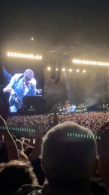 Elton John is seen on a jumbotron, as he reacts after prematurely ending his show, at the Mount Smart Stadium in Auckland