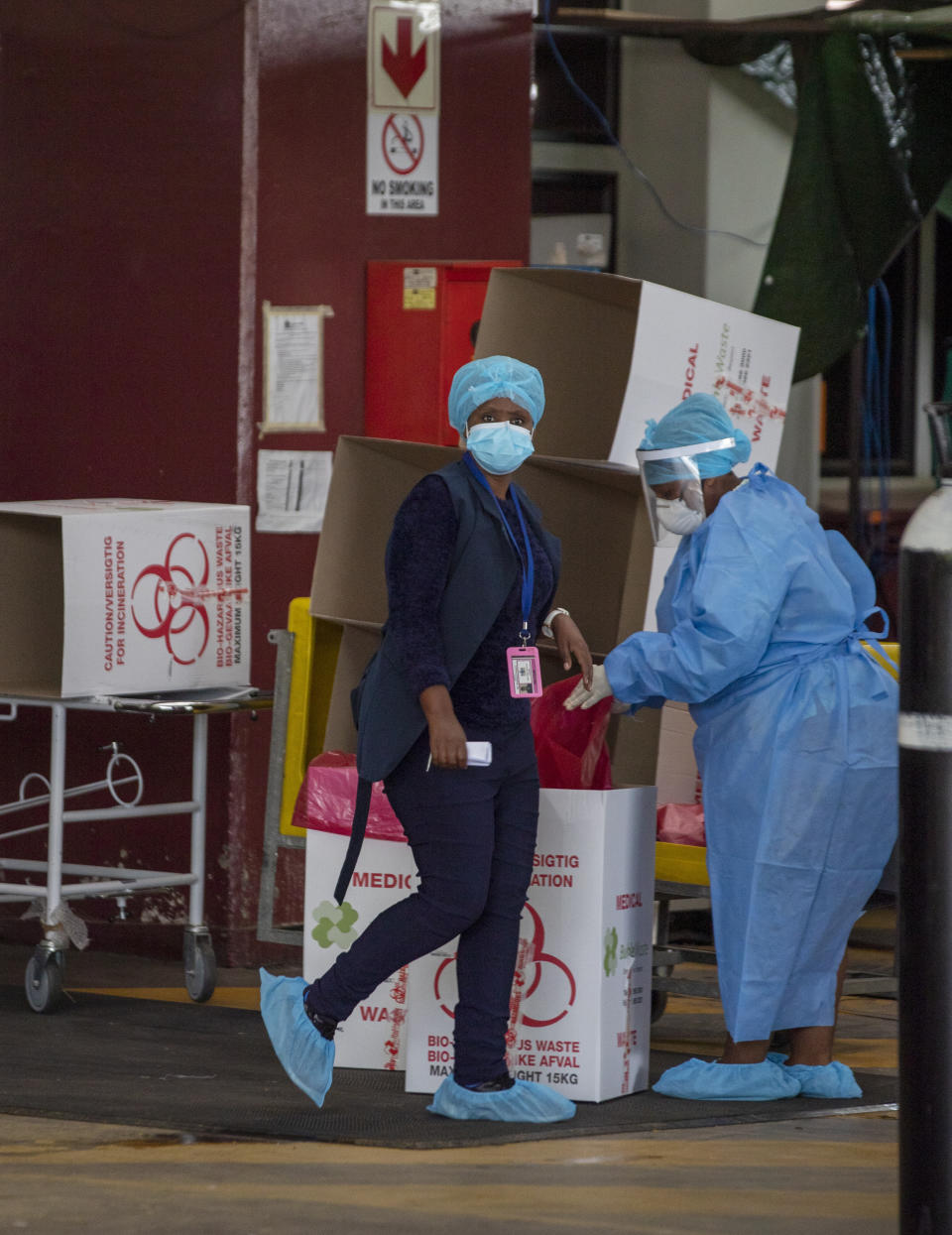 Health workers in protective geart, at a makeshift emergency unit at the Steve Biko Academic Hospital in Pretoria, South Africa, Monday, Jan. 11, 2021, which is battling an ever-increasing number of COVID-19 patients. (AP Photo/Themba Hadebe)