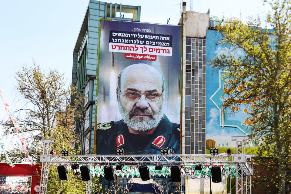 Iran's slain Brigadier General Mohammad Reza Zahedi appears on a billboard on April 3, 2024 in Palestine Square in Tehran. A slogan in Hebrew reads, 