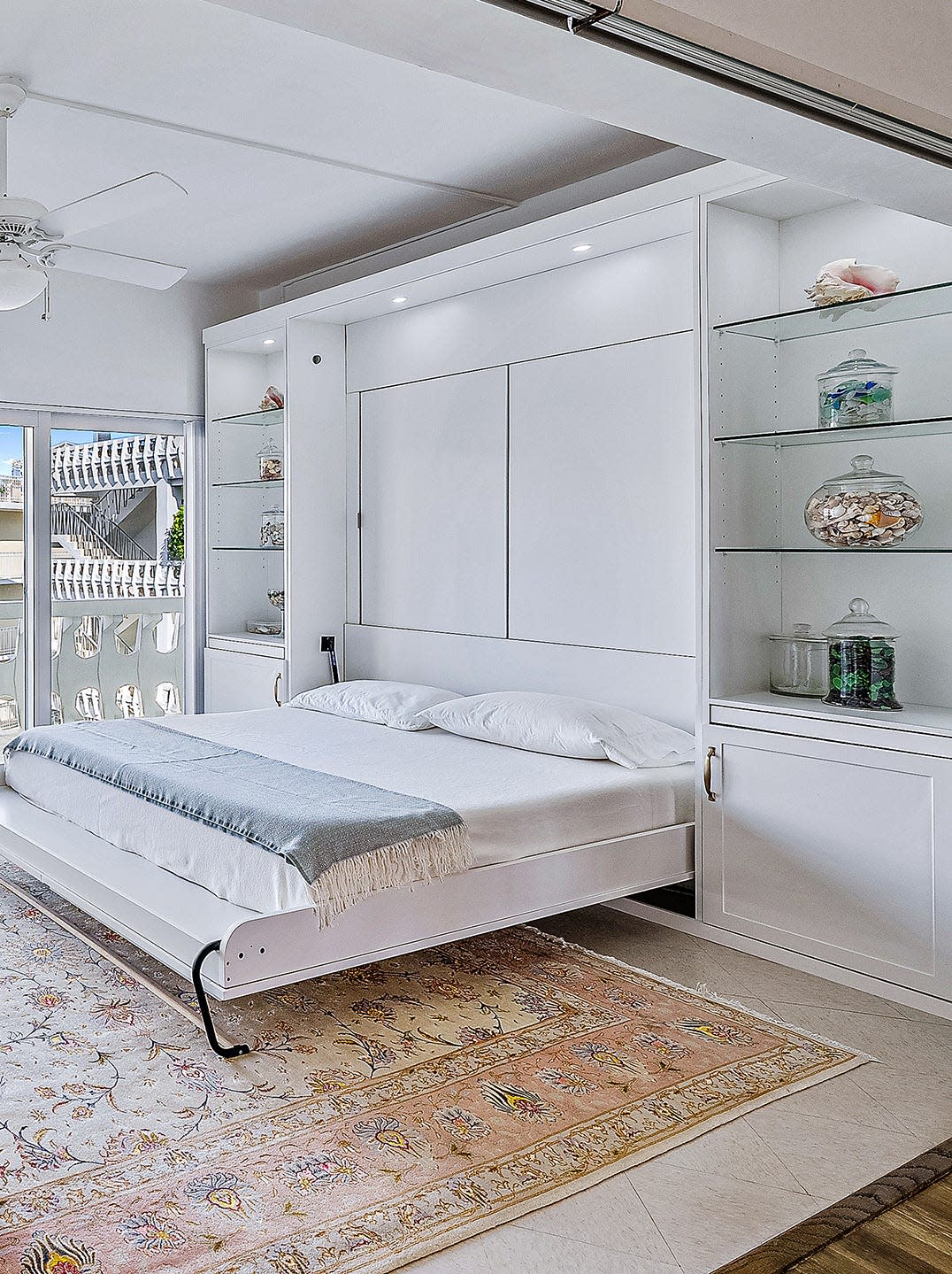 The Paulinos added built-in cabinetry and a pull-down Murphy bed to the sunroom.