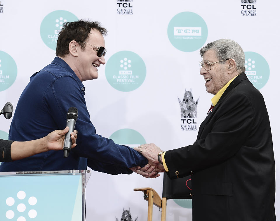 Director Quentin Tarantino shakes hands with actor and comedian Jerry Lewis as Lewis is honored with a hand and footprint ceremony at TCL Chinese Theatre on Saturday, April 12, 2014 in Los Angeles. (Photo by Dan Steinberg/Invision/AP Images)