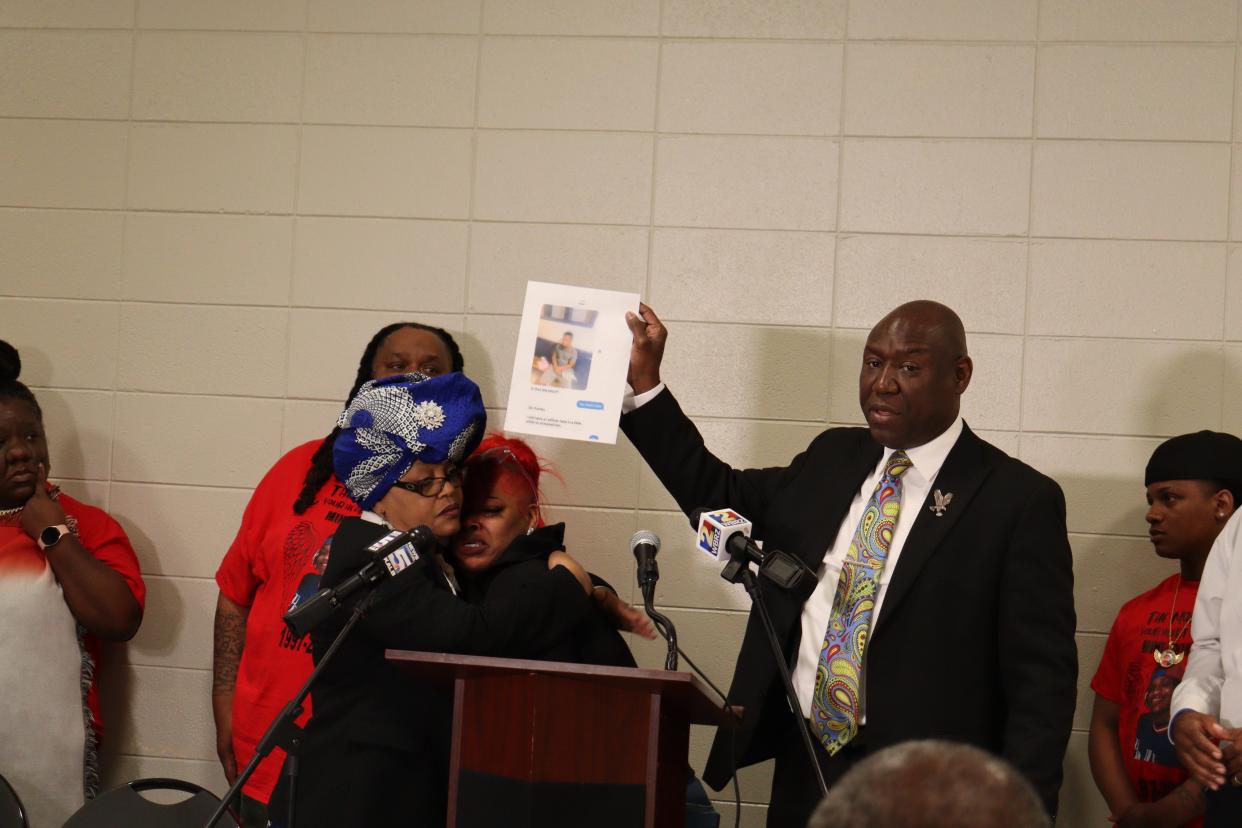 Attorney Benjamin Crump (right) holds a copy of a text message about Jerome Stevenson, who died on Nov. 6 after being beaten in the Avoyelles Parish Detention Center #1 two days earlier. Crump is representing Stevenson's family. Monica Battley-Fabre (left), a family spokesperson, holds Stevenson's fiancée, Liddie Ballard, after she spoke during a Friday press conference.