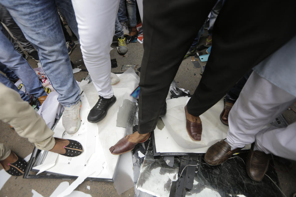 Karni Sena supporters trample on China-made products during a protest against China in Ahmedabad, India, Wednesday, June 24, 2020. Chinese and Indian military commanders have agreed to disengage their forces in a disputed area of the Himalayas following a clash that left at least 20 soldiers dead, both countries said Tuesday. The commanders reached the agreement Monday in their first meeting since the June 15 confrontation, the countries said. (AP Photo/Ajit Solanki)