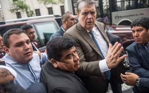 Alan Garcia arriving at the prosecutor's office in Lima in November - Credit: AFP