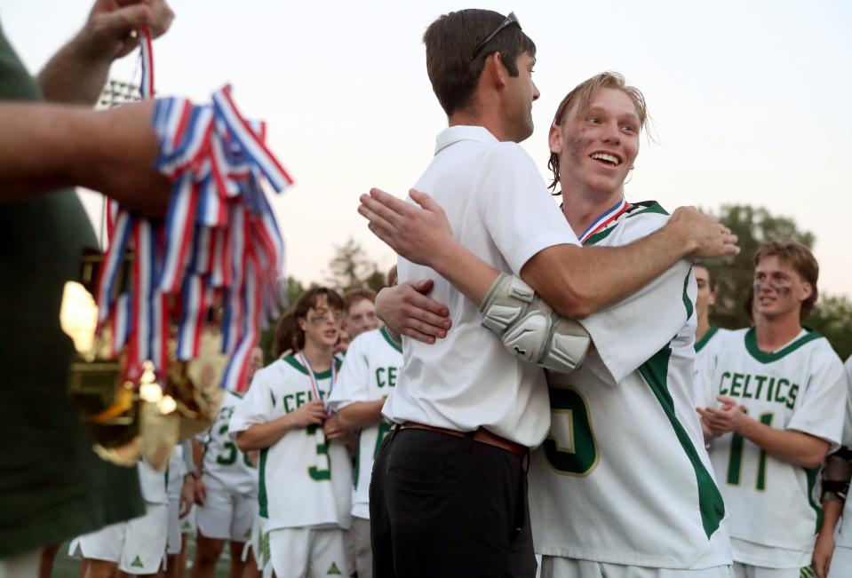 5. Dublin Jerome's Preston Stucke receives his championship medal from coach Andy Asmo after the Celtics defeated Upper Arlington 12-11 in the Division I state boys lacrosse final June 5 at Ohio Wesleyan. It was the Celtics' fourth state title.