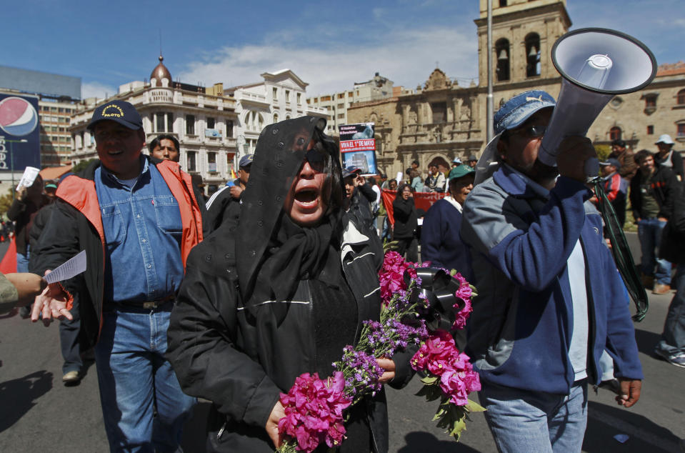 A woman dressed in black mourning colors shouts slogans against the government of Bolivia's President Evo Morales during a May Day march in La Paz, Bolivia, Tuesday, May 1, 2012. Morales announced Tuesday his government is completing the nationalization of the country's electricity industry by taking over its electrical grid from a Spanish-owned company. (AP Photo/Juan Karita)