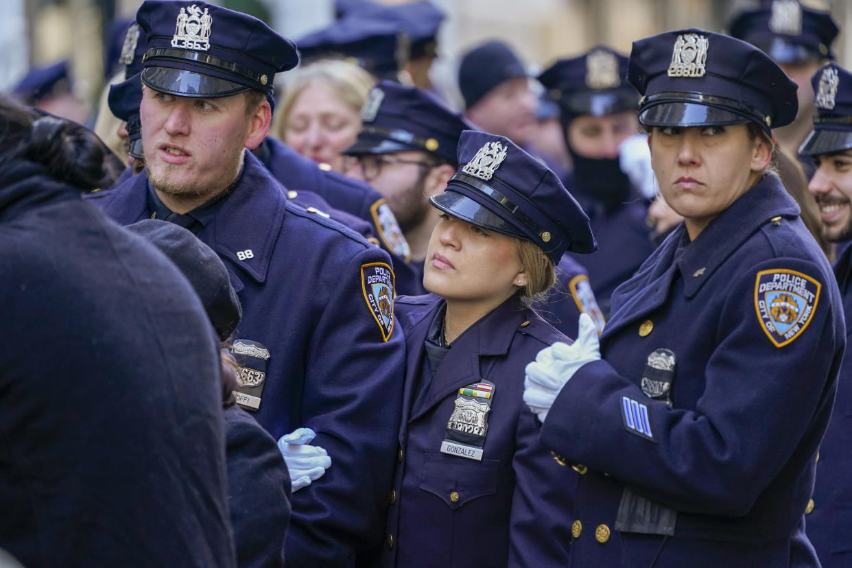 Police officers stand in line outside St. Patricks Cathedral to pay their respects during the wake of New York City Police Officer Jason Rivera, Thursday, Jan. 27, 2022, in New York. Rivera was fatally shot Friday, Jan. 21, while answering a call about an argument between a woman and her adult son. (AP Photo/Mary Altaffer)