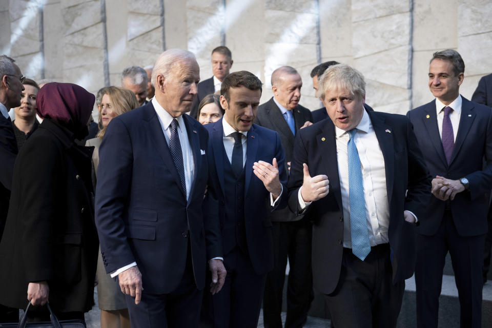 President Joe Biden, left, talks with French President Emmanuel Macron and Briitish Prime Minister Boris Johnson, right, as they arrive at NATO Headquarters in Brussels, Thursday, March 24, 2022. (Brendan Smialowski, Pool via AP)