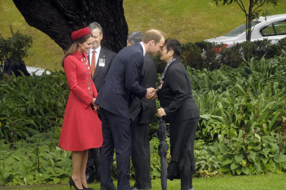 Britain's Prince William is watched by his wife Catherine as he receives a Maori welcome known as a 'Hongi' in Wellington