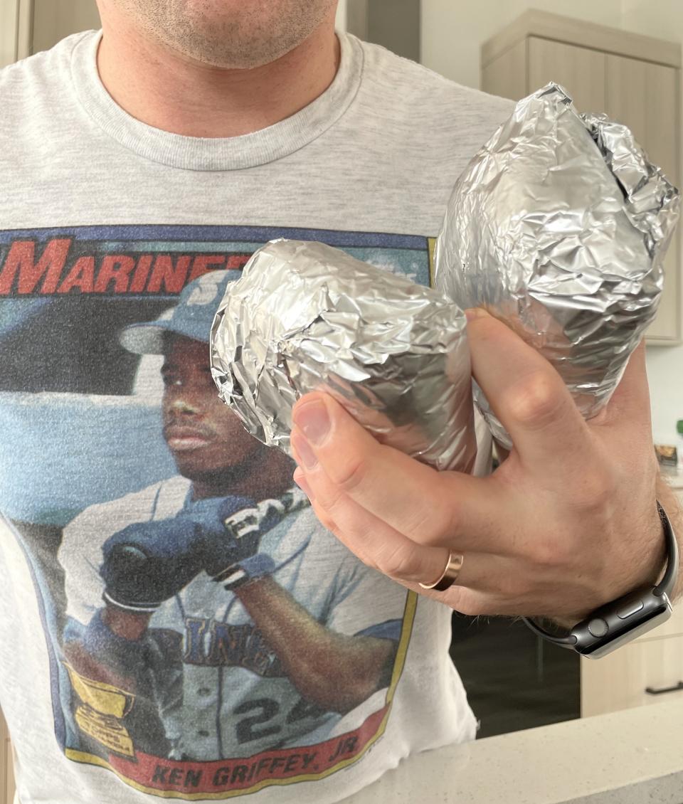 the author's husband holding breakfast sandwiches