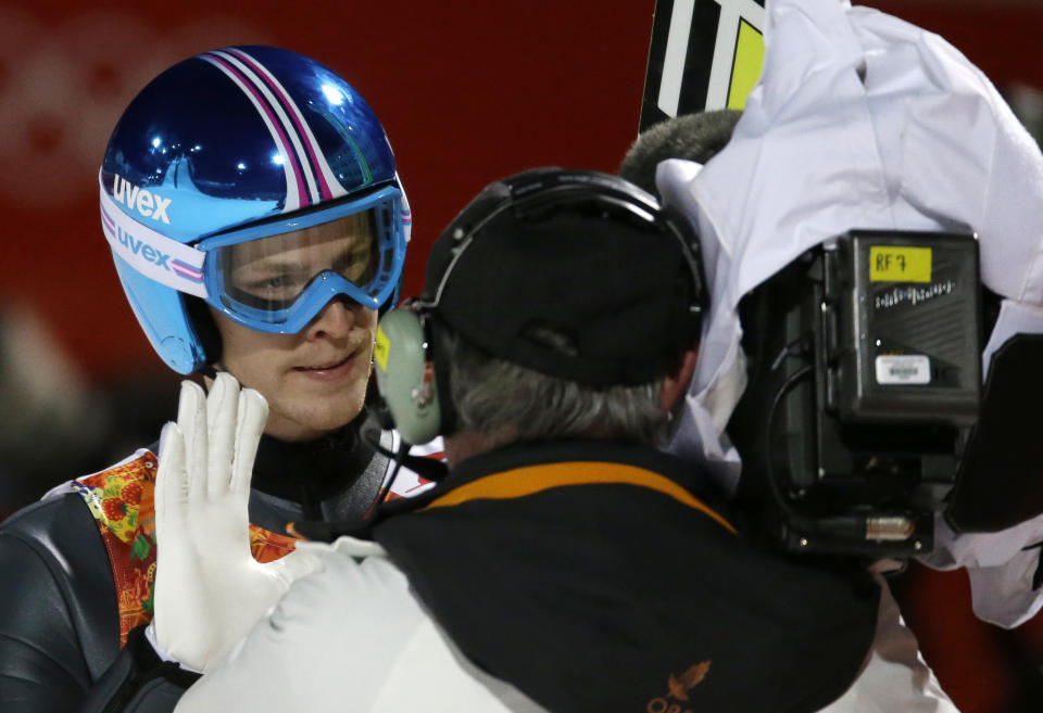 Austria's Michael Hayboeck waves to a camera after his first attempt during the men's normal hill ski jumping final at the 2014 Winter Olympics, Sunday, Feb. 9, 2014, in Krasnaya Polyana, Russia. (AP Photo/Gregorio Borgia)