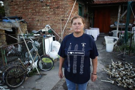 Milica Milkovic, a packaging worker with Serbian farming company Agroziv, poses in front of her home in the village of Srpski Itebej, near Vrsac July 7, 2014. REUTERS/Djordje Kojadinovic