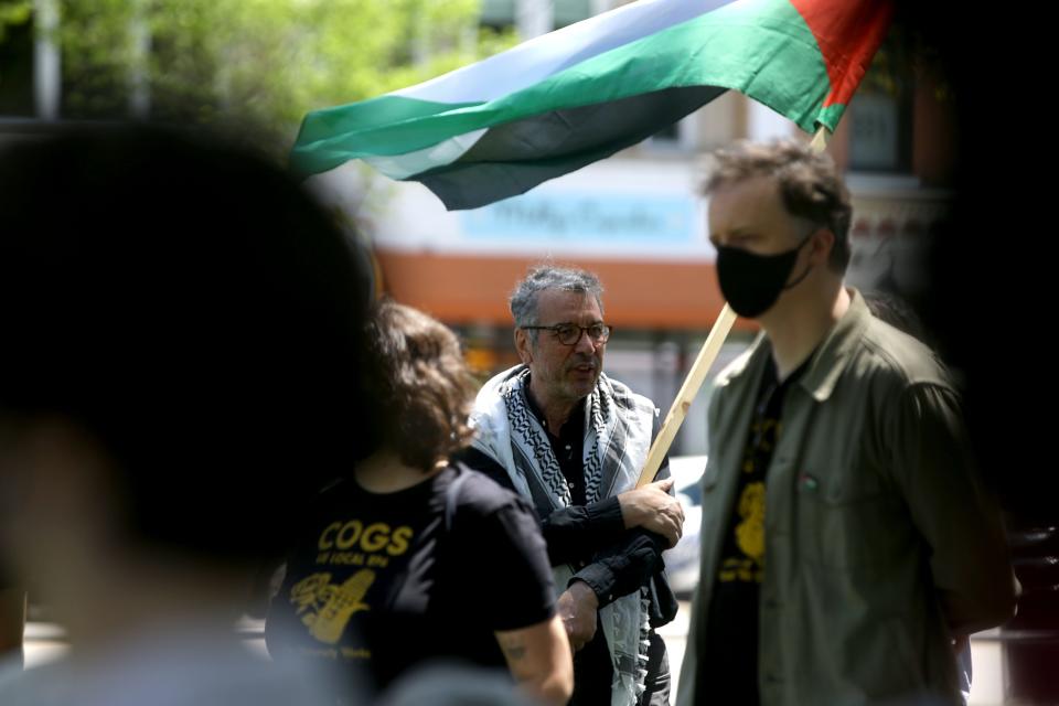 Newman Abuissa holds a Palestinian flag during a demonstration and educational event concerning the Israel-Hamas war Friday, May 3, 2024 on the Pentacrest in Iowa City, Iowa.
