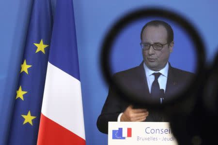 France's President Francois Hollande is seen through a camera filter during a news conference at a European Union leaders summit in Brussels December 18, 2014. REUTERS/Pascal Rossignol