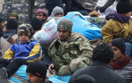 Rebel fighters and civilians gather as they wait to be evacuated from a rebel-held sector of eastern Aleppo, Syria December 16, 2016. REUTERS/Abdalrhman Ismail