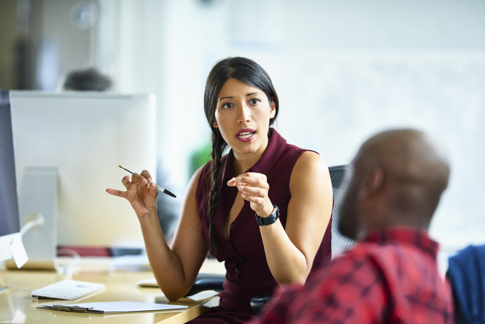 man and woman talking in an office