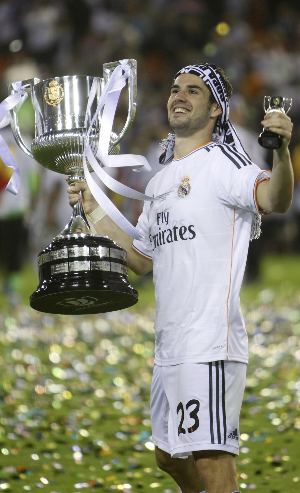 Real's Isco celebrates with the trophy after Real Madrid won the final of the Copa del Rey between FC Barcelona and Real Madrid at the Mestalla stadium in Valencia, Spain, Wednesday, April 16, 2014. (AP Photo/Alberto Saiz)