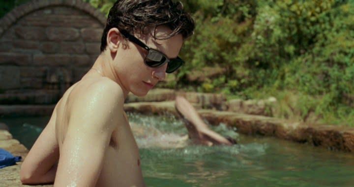 A boy sits by a pool in Call Me By Your Name.