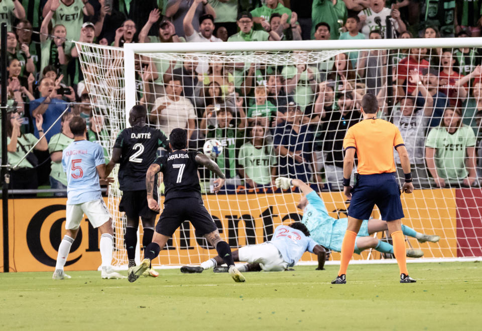 Austin FC forward Moussa Djitte (2) scores a goal against FC Dallas goalkeeper Maarten Paes, second from right, during the first half an MLS playoff soccer match, Sunday, Oct. 23, 2022, in Austin, Texas. (AP Photo/Michael Thomas)