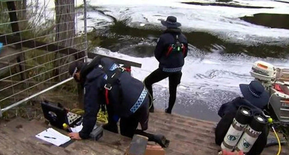 Divers stand at the edge of the river where eight-year-old Sol went missing. 