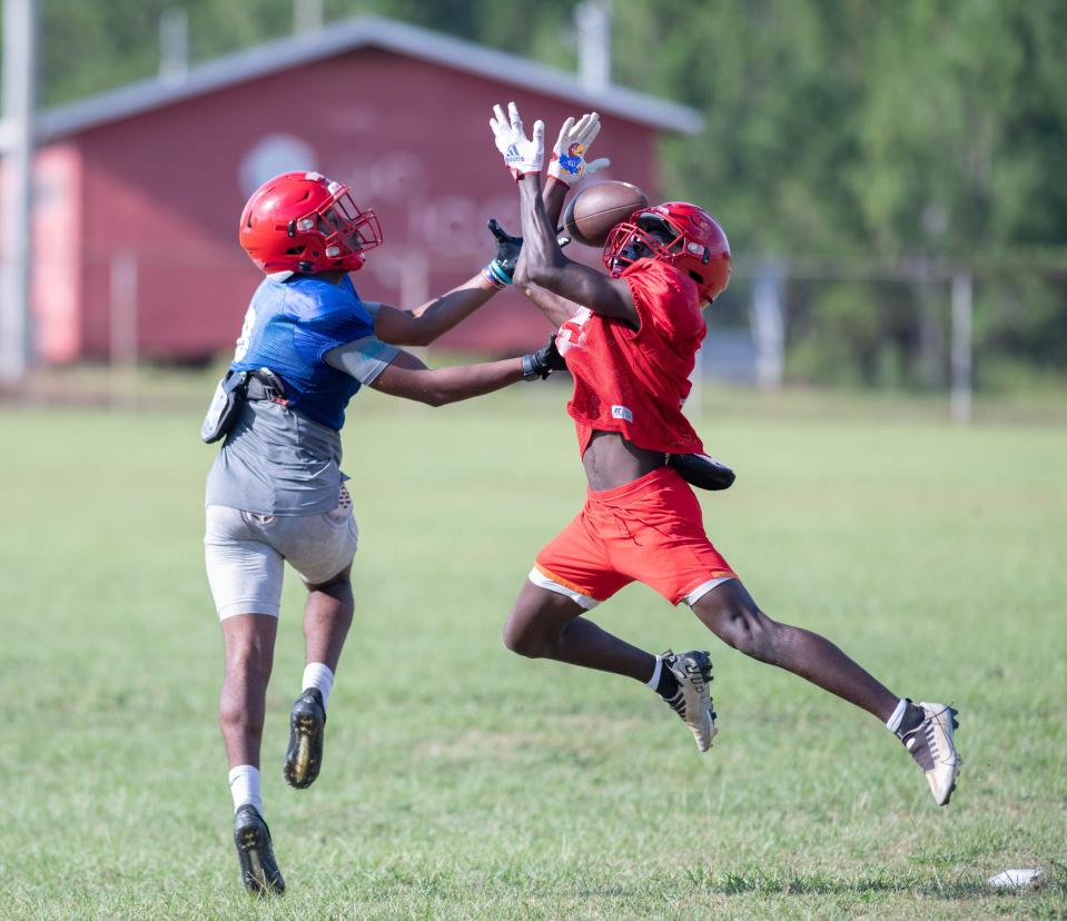Ty'jawan Stabler (8) and his teammate vie for the ball during football practice at Pine Forest High School in Pensacola on Wednesday, Aug. 16, 2023.