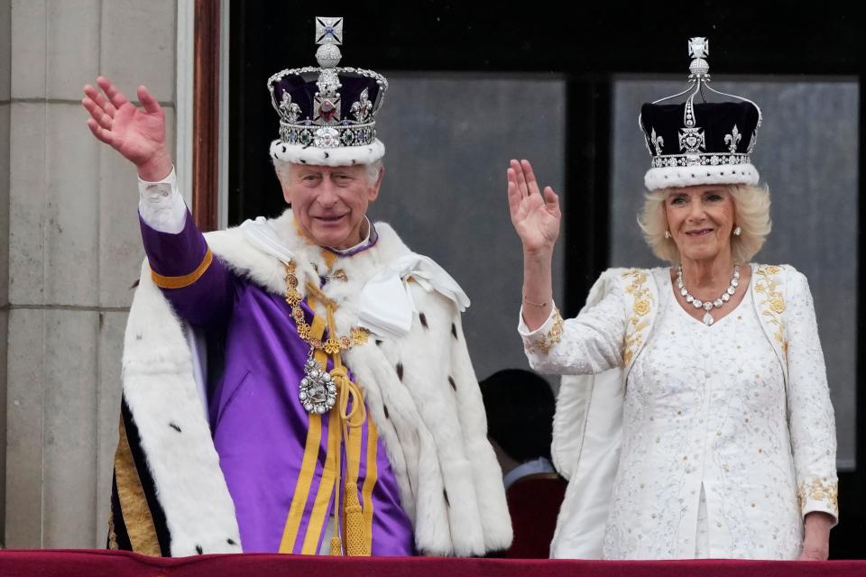 Britain's King Charles III and Queen Camilla wave to crowds from the balcony of Buckingham Palace after the coronation ceremony in London, on May 6, 2023.