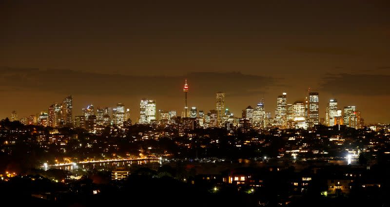 Sydney's central business district lights up after sunset as Australia's largest city experiences unseasonably warm temperatures