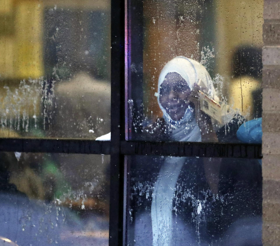 A displaced resident looks out a window after a deadly fire at a high-rise apartment building Wednesday, Nov. 27, 2019, in Minneapolis. (David Joles/Star Tribune via AP)