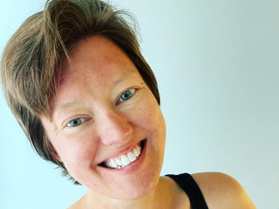 The author, Rachel Garlinghouse, in a black tank top smiling at the camera