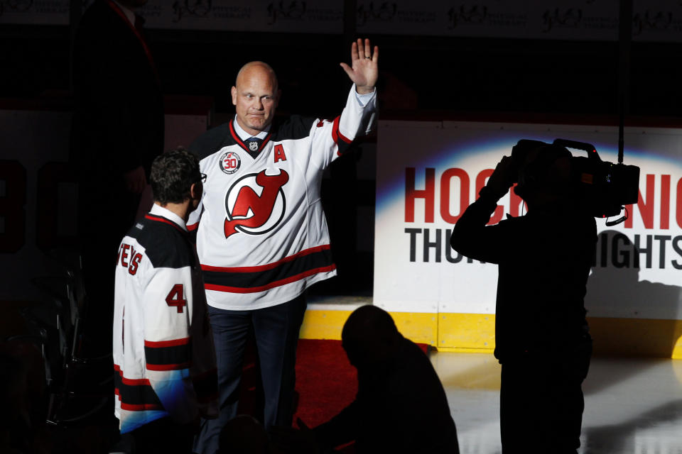 FILE - Retired New Jersey Devils defenseman Ken Daneyko waves as he arrives at the Prudential Center arena as the Devils retire former star goalie Martin Brodeur's number 30 jersey, Tuesday, Feb. 9, 2016, in Newark, N.J. Daneyko likes how 3-on-3 OT works right now, but he's open to seeing what it's like in his first season behind the bench with 3ICE before making a judgment. (AP Photo/Mel Evans, File)