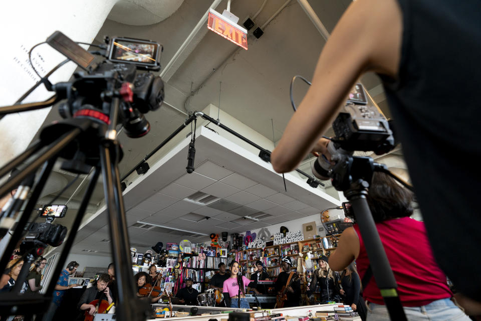 NPR videographers film while Becky G performs during a taping for NPR's Tiny Desk concert series on Wednesday, Aug. 30, 2023, in Washington. (AP Photo/Stephanie Scarbrough)